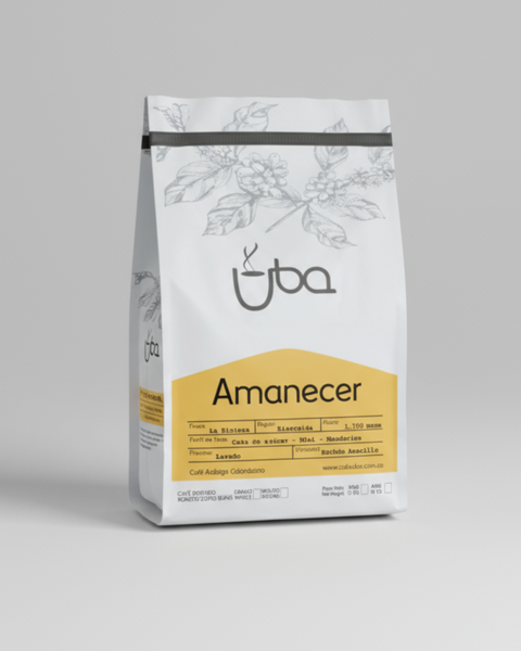 Coffee bag labeled 'Amanecer' by Uba on a gray background